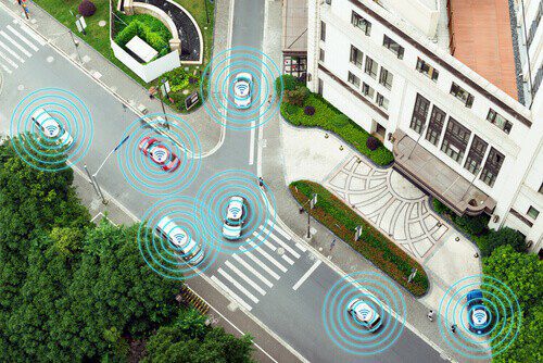 several cars in autonomous self-driving mode on metro city road iot concept
